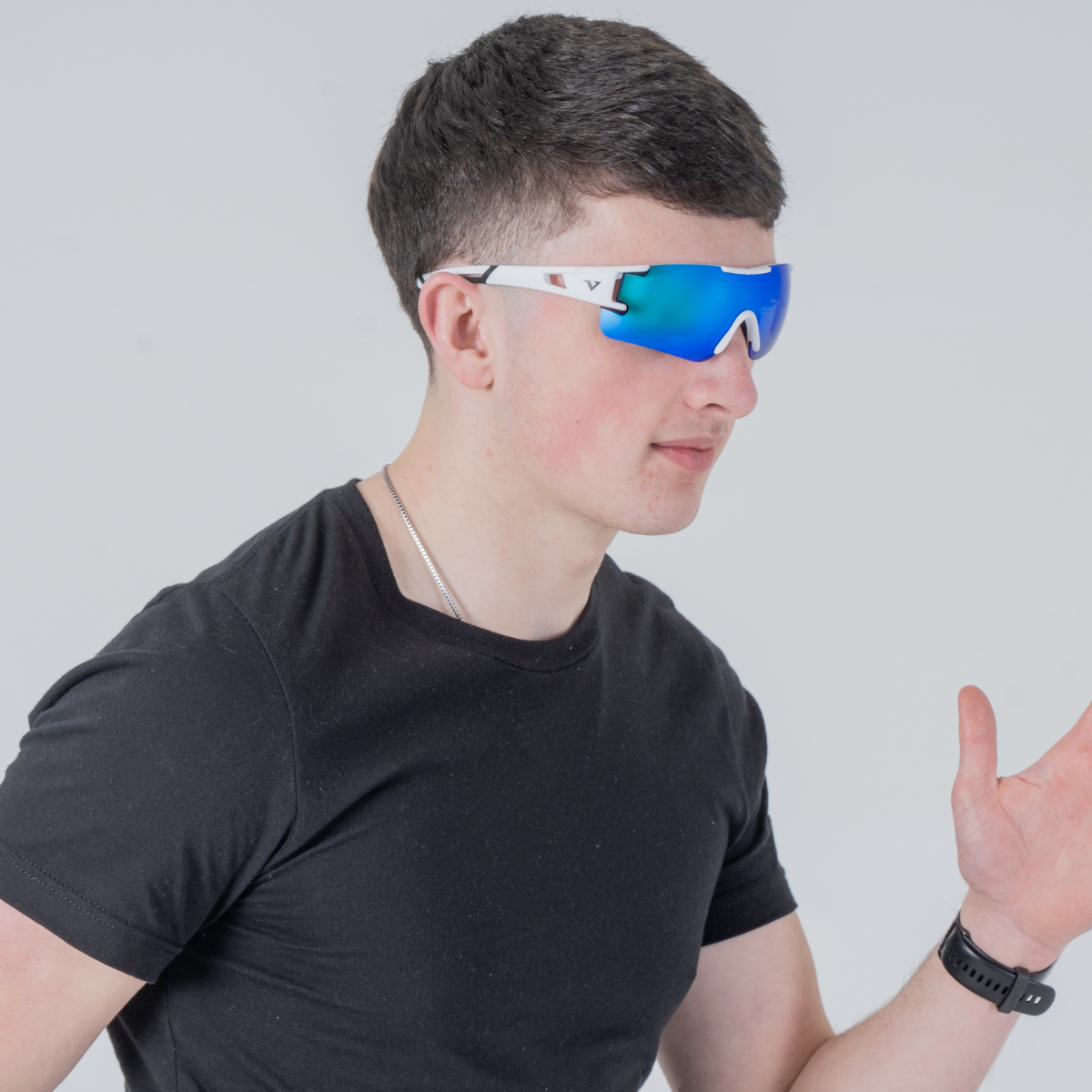 Side facing male model wearing the blue/white velocity apex performance sunglasses designed for hyrox training