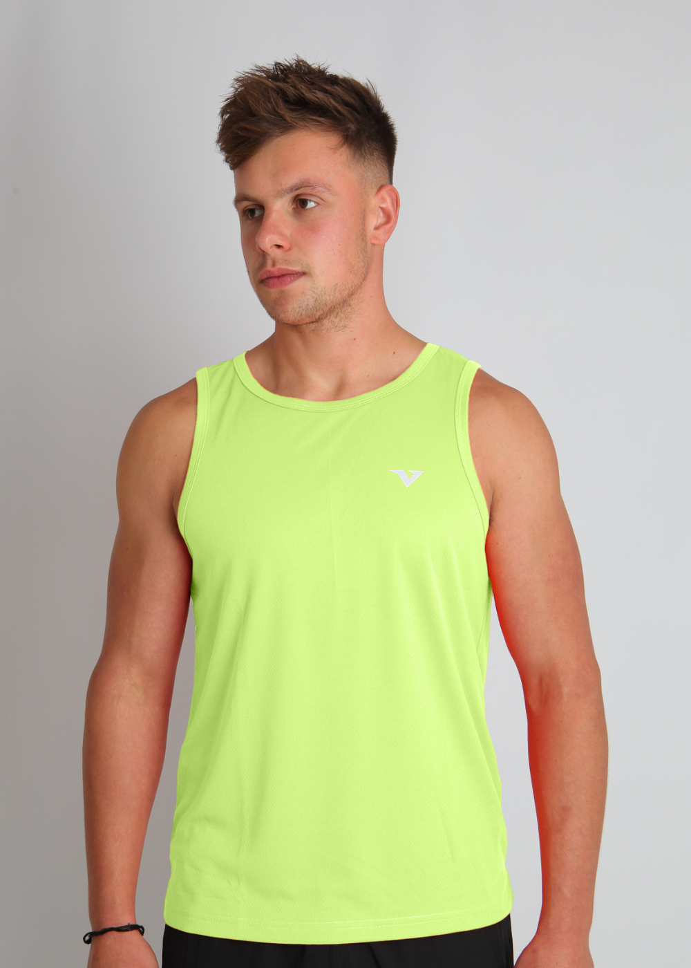 Male runner wearing a Volt fluorescent yellow Verox HexFlow™ tank top, showcasing lightweight, moisture-wicking running fabric for optimal performance.